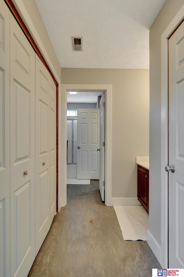 7627 S 38th St, Lincoln, NE 68516 - corridor with baseboards and a textured ceiling