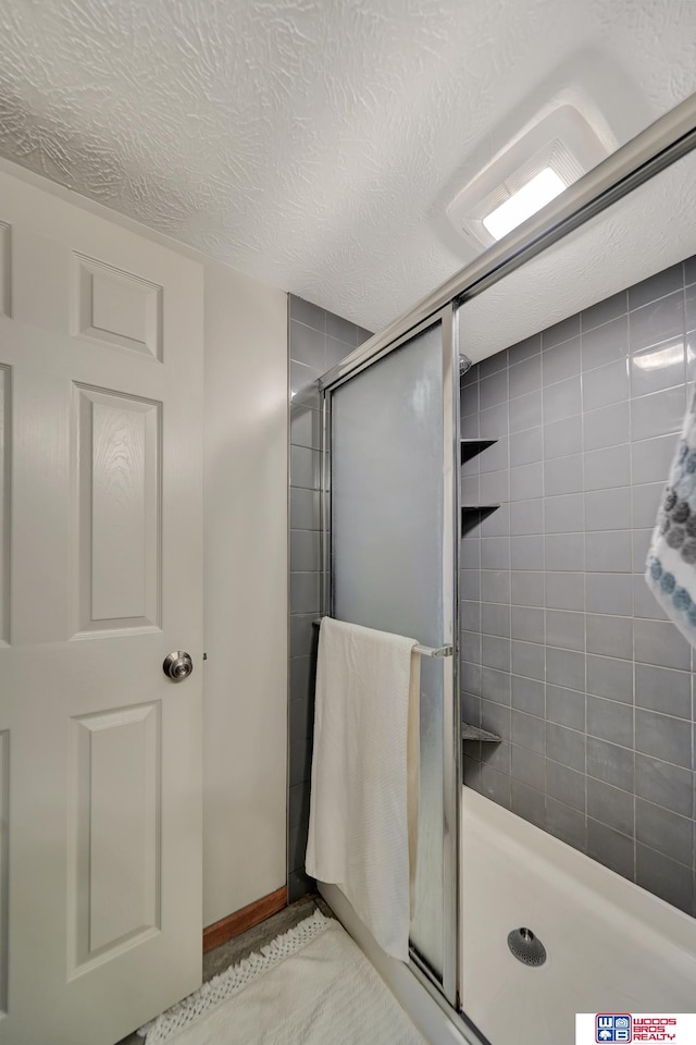 7627 S 38th St, Lincoln, NE 68516 - full bath featuring a shower stall and a textured ceiling