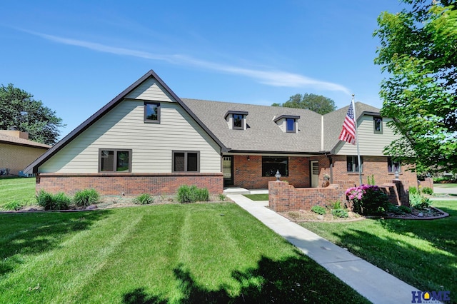 4801 S 72nd St, Lincoln, NE 68516 - view of front of property with brick siding, a front yard, and roof with shingles