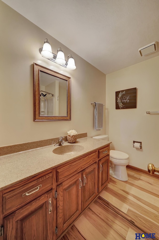 4801 S 72nd St, Lincoln, NE 68516 - full bath featuring vanity, wood finished floors, toilet, and a shower with shower curtain