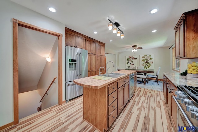 4801 S 72nd St, Lincoln, NE 68516 - kitchen featuring appliances with stainless steel finishes, butcher block countertops, a kitchen island with sink, recessed lighting, and ceiling fan