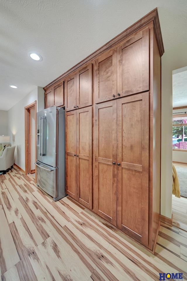 4801 S 72nd St, Lincoln, NE 68516 - kitchen with high quality fridge, recessed lighting, brown cabinets, light wood-style floors, and baseboards