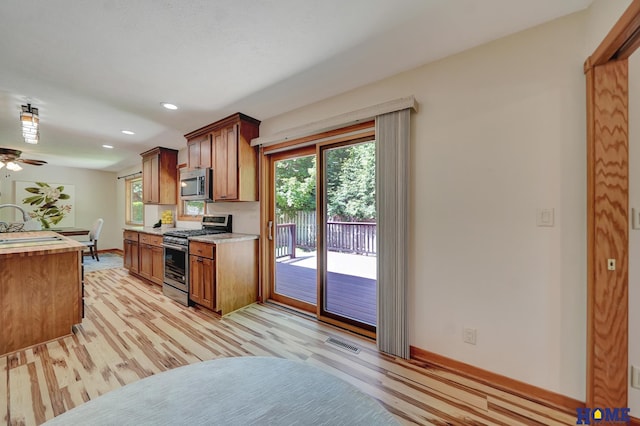 4801 S 72nd St, Lincoln, NE 68516 - kitchen with stainless steel appliances, light wood-style floors, healthy amount of natural light, light countertops, and recessed lighting