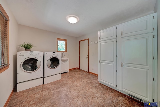 4801 S 72nd St, Lincoln, NE 68516 - washroom with separate washer and dryer, cabinet space, and baseboards