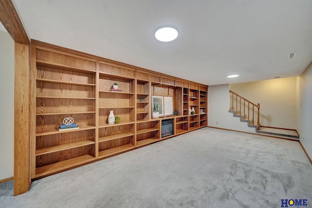 4801 S 72nd St, Lincoln, NE 68516 - unfurnished living room with carpet floors, baseboards, stairway, and built in features