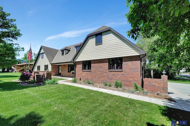 4801 S 72nd St, Lincoln, NE 68516 - rear view of property with brick siding, a lawn, and a shingled roof