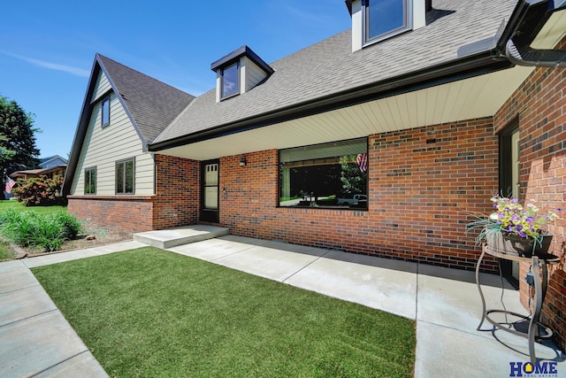 4801 S 72nd St, Lincoln, NE 68516 - rear view of house featuring brick siding, roof with shingles, and a lawn