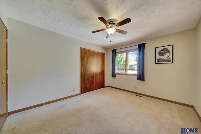 4801 S 72nd St, Lincoln, NE 68516 - unfurnished bedroom featuring light carpet, a closet, a textured ceiling, and baseboards