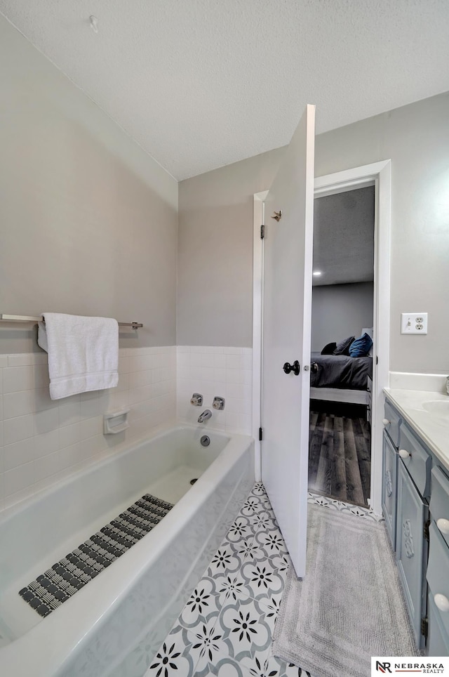 6844 Laurent Cir, Lincoln, NE 68526 - ensuite bathroom with a garden tub, vanity, and a textured ceiling
