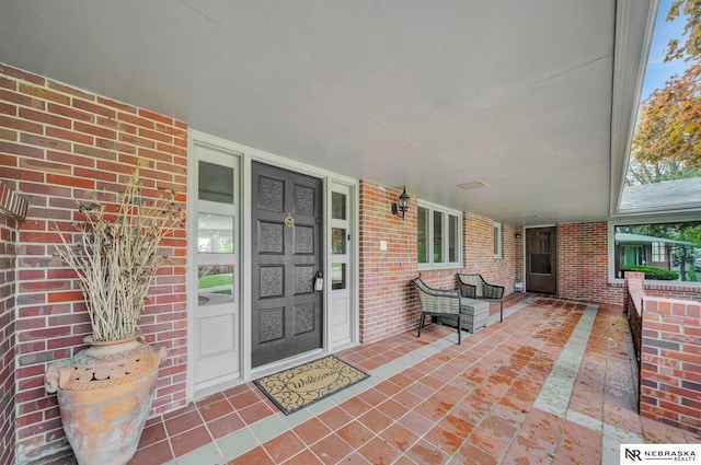 6844 Laurent Cir, Lincoln, NE 68526 - doorway to property with brick siding and covered porch
