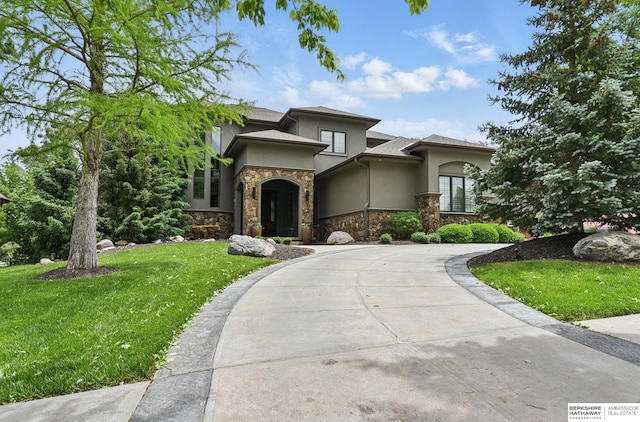 1419 N 188th St, Elkhorn, NE 68022 - view of front of home featuring stucco siding, stone siding, curved driveway, and a front yard