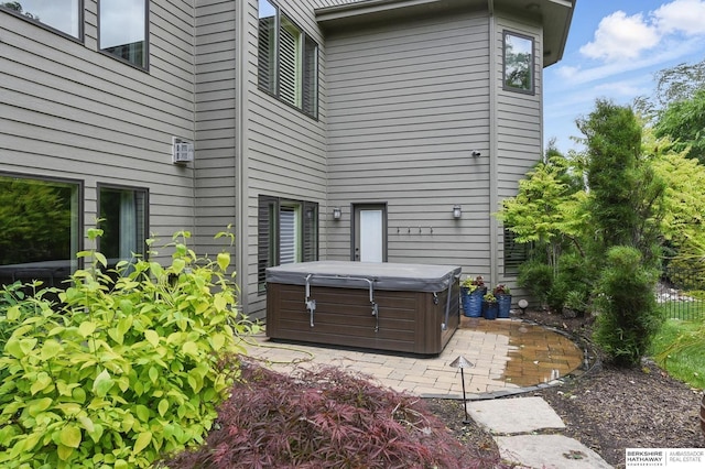 1419 N 188th St, Elkhorn, NE 68022 - rear view of property with a hot tub and a patio area
