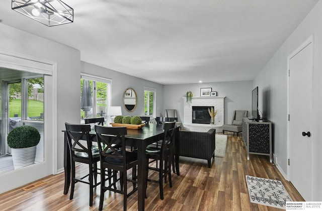 1725 N 162nd St, Omaha, NE 68118 - dining space with a brick fireplace and wood finished floors
