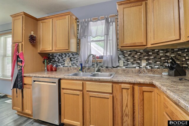 950 E 16th St, Fremont, NE 68025 - kitchen with stainless steel dishwasher, a sink, tasteful backsplash, and light countertops