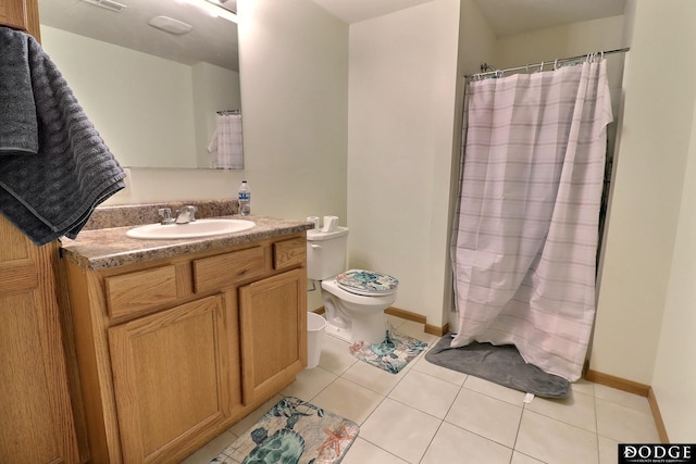 950 E 16th St, Fremont, NE 68025 - full bath with toilet, tile patterned floors, vanity, curtained shower, and baseboards