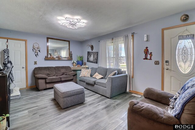 950 E 16th St, Fremont, NE 68025 - living area with light wood-style floors, baseboards, and a textured ceiling