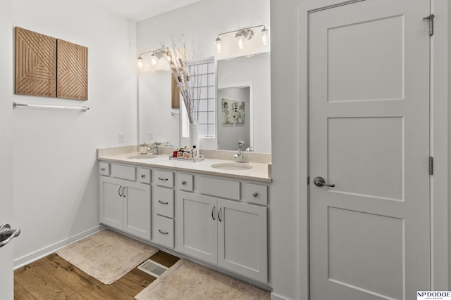 7717 N 108th St, Omaha, NE 68142 - full bath featuring double vanity, wood finished floors, and baseboards