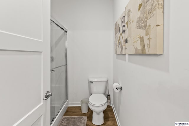 7717 N 108th St, Omaha, NE 68142 - full bathroom with a shower with shower door, wood finished floors, toilet, and baseboards