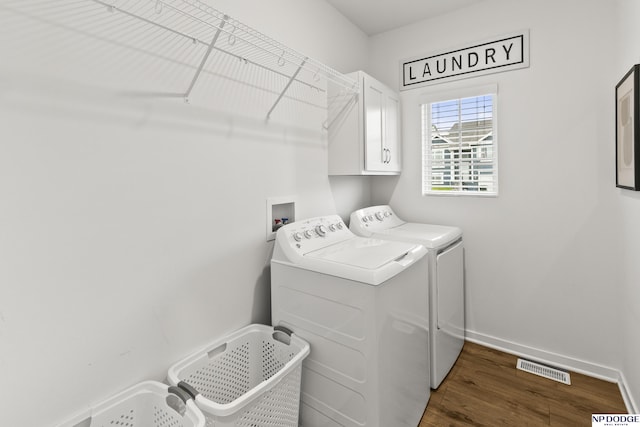 7717 N 108th St, Omaha, NE 68142 - laundry area featuring washing machine and clothes dryer, cabinet space, baseboards, and wood finished floors