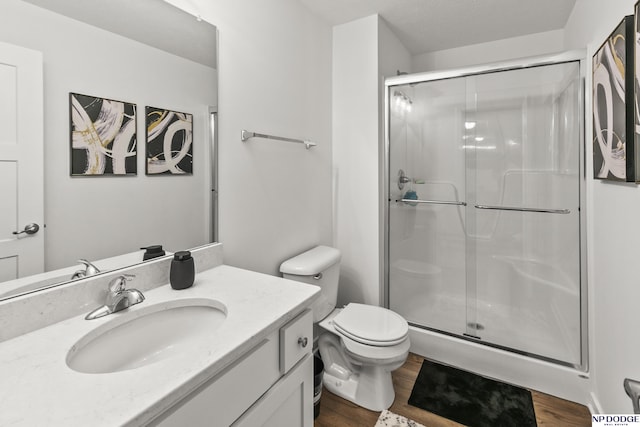 7717 N 108th St, Omaha, NE 68142 - bathroom with a shower stall, vanity, toilet, and wood finished floors