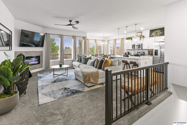 7717 N 108th St, Omaha, NE 68142 - carpeted living room featuring a ceiling fan and a glass covered fireplace