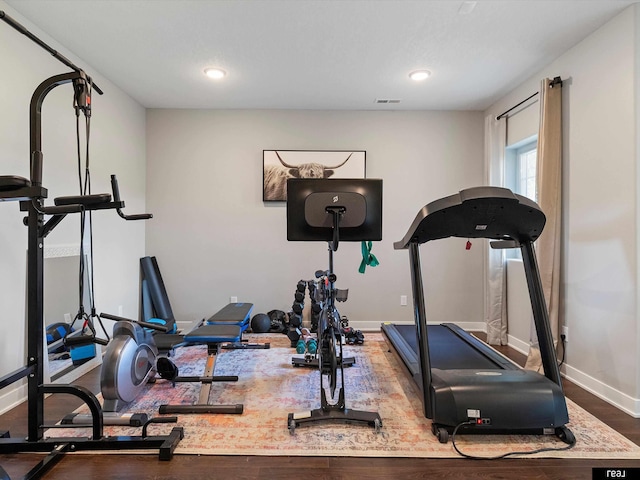 947 250th St, Avoca, IA 51521 - exercise area featuring baseboards, wood finished floors, and recessed lighting