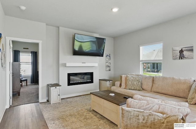 6312 Centennial Rd, Papillion, NE 68157 - living room featuring light wood-style floors, a glass covered fireplace, baseboards, and recessed lighting
