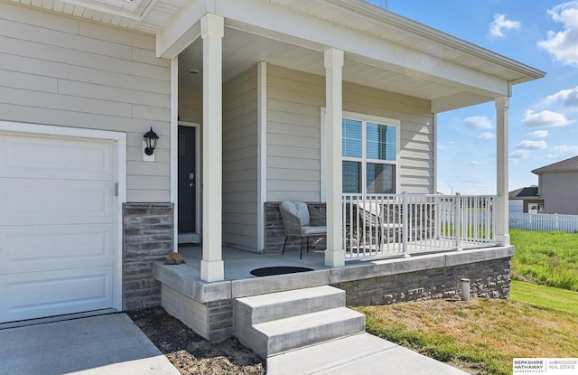 6312 Centennial Rd, Papillion, NE 68157 - entrance to property with a porch, a garage, and stone siding