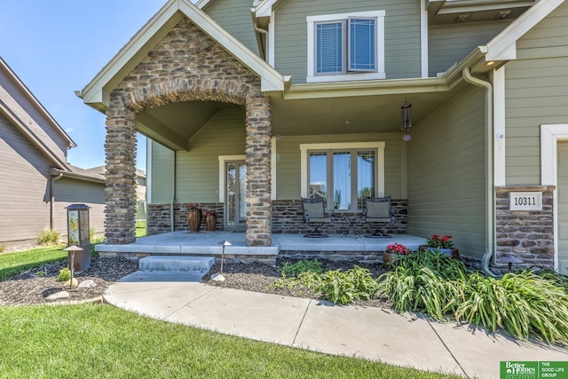 10311 S 124th St, Papillion, NE 68046 - doorway to property featuring a porch and stone siding