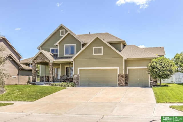 10311 S 124th St, Papillion, NE 68046 - craftsman inspired home featuring a porch, concrete driveway, stone siding, and roof with shingles