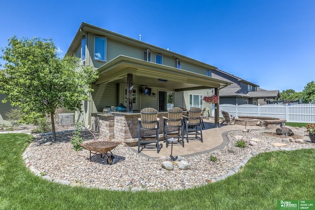 10311 S 124th St, Papillion, NE 68046 - rear view of property with an outdoor fire pit and a patio area