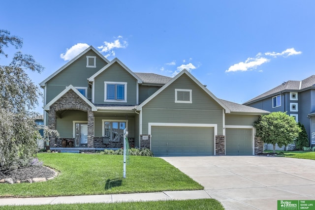 10311 S 124th St, Papillion, NE 68046 - craftsman house featuring a porch, driveway, a front yard, stone siding, and an attached garage