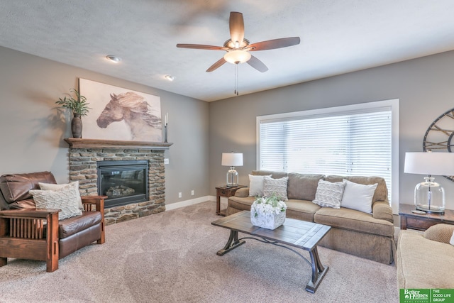 10311 S 124th St, Papillion, NE 68046 - living area featuring a ceiling fan, carpet, a stone fireplace, and baseboards
