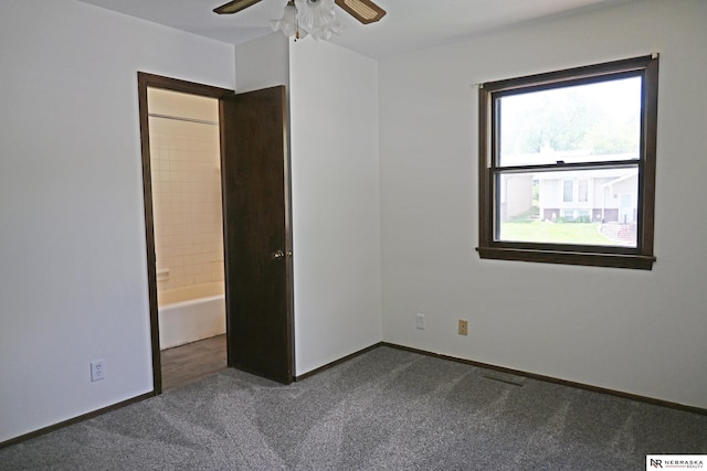 4841 N 130th Cir, Omaha, NE 68164 - unfurnished bedroom featuring dark colored carpet, baseboards, ceiling fan, and connected bathroom