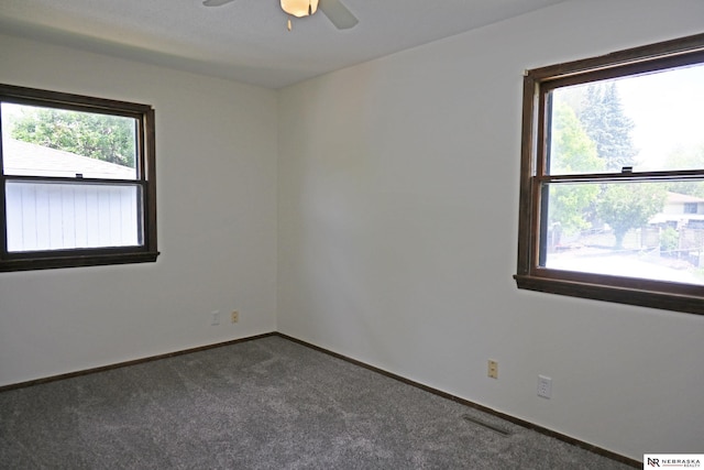 4841 N 130th Cir, Omaha, NE 68164 - spare room featuring dark carpet, a ceiling fan, and baseboards