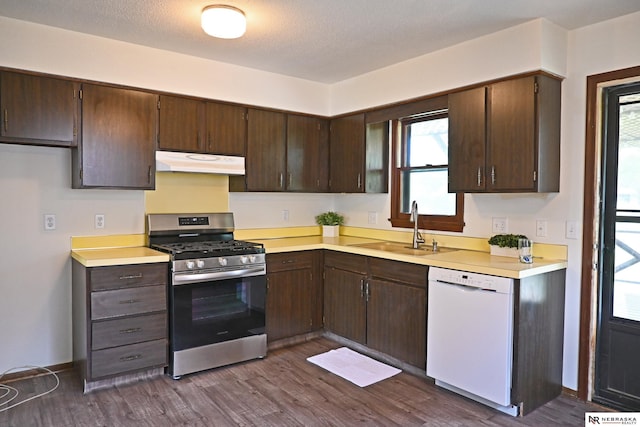 4841 N 130th Cir, Omaha, NE 68164 - kitchen with gas range, dishwasher, under cabinet range hood, a sink, and light countertops