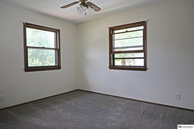 4841 N 130th Cir, Omaha, NE 68164 - empty room with dark carpet, a ceiling fan, and baseboards