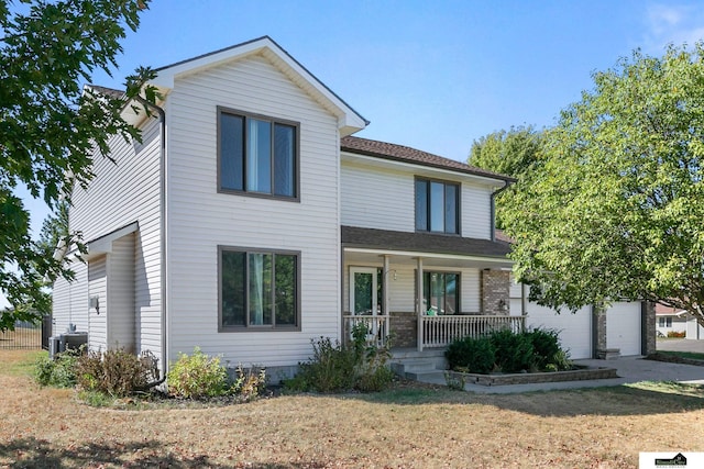 9521 N 140th St, Waverly, NE 68462 - view of front of house featuring a porch, a garage, a front yard, and central air condition unit