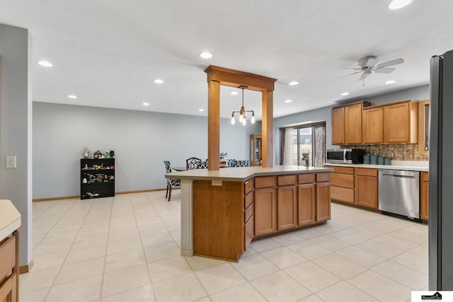 9521 N 140th St, Waverly, NE 68462 - kitchen featuring stainless steel appliances, ceiling fan, recessed lighting, brown cabinets, and light countertops