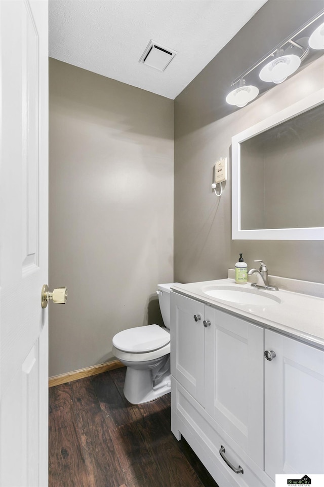 9521 N 140th St, Waverly, NE 68462 - bathroom featuring vanity, wood finished floors, toilet, and baseboards