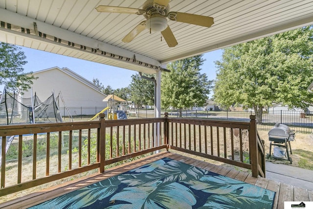 9521 N 140th St, Waverly, NE 68462 - deck with a trampoline, a ceiling fan, and a playground