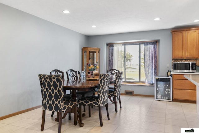 9521 N 140th St, Waverly, NE 68462 - dining area with wine cooler, recessed lighting, baseboards, and light tile patterned floors
