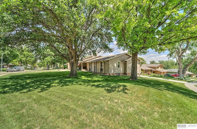 1915 S 131st Ave, Omaha, NE 68144 - view of front facade with a front yard and board and batten siding