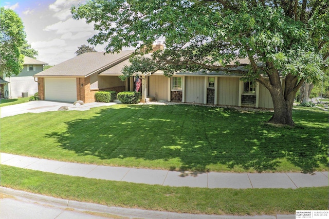 1915 S 131st Ave, Omaha, NE 68144 - view of front facade featuring driveway, a front lawn, an attached garage, and a chimney