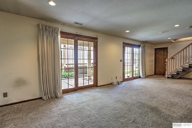 1915 S 131st Ave, Omaha, NE 68144 - unfurnished living room featuring a textured ceiling, stairs, carpet flooring, baseboards, and recessed lighting