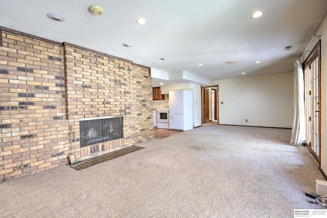 1915 S 131st Ave, Omaha, NE 68144 - unfurnished living room with light carpet, a brick fireplace, recessed lighting, baseboards, and brick wall