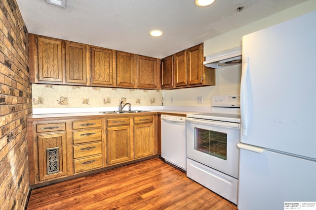 1915 S 131st Ave, Omaha, NE 68144 - kitchen featuring white appliances, a sink, under cabinet range hood, brown cabinets, and recessed lighting