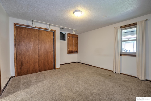 1915 S 131st Ave, Omaha, NE 68144 - unfurnished bedroom with a textured ceiling, light carpet, a closet, baseboards, and track lighting