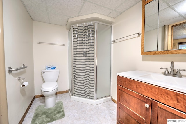1915 S 131st Ave, Omaha, NE 68144 - bathroom with a paneled ceiling, a stall shower, vanity, toilet, and baseboards