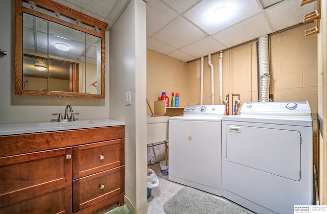 1915 S 131st Ave, Omaha, NE 68144 - washroom with independent washer and dryer, concrete block wall, and a sink
